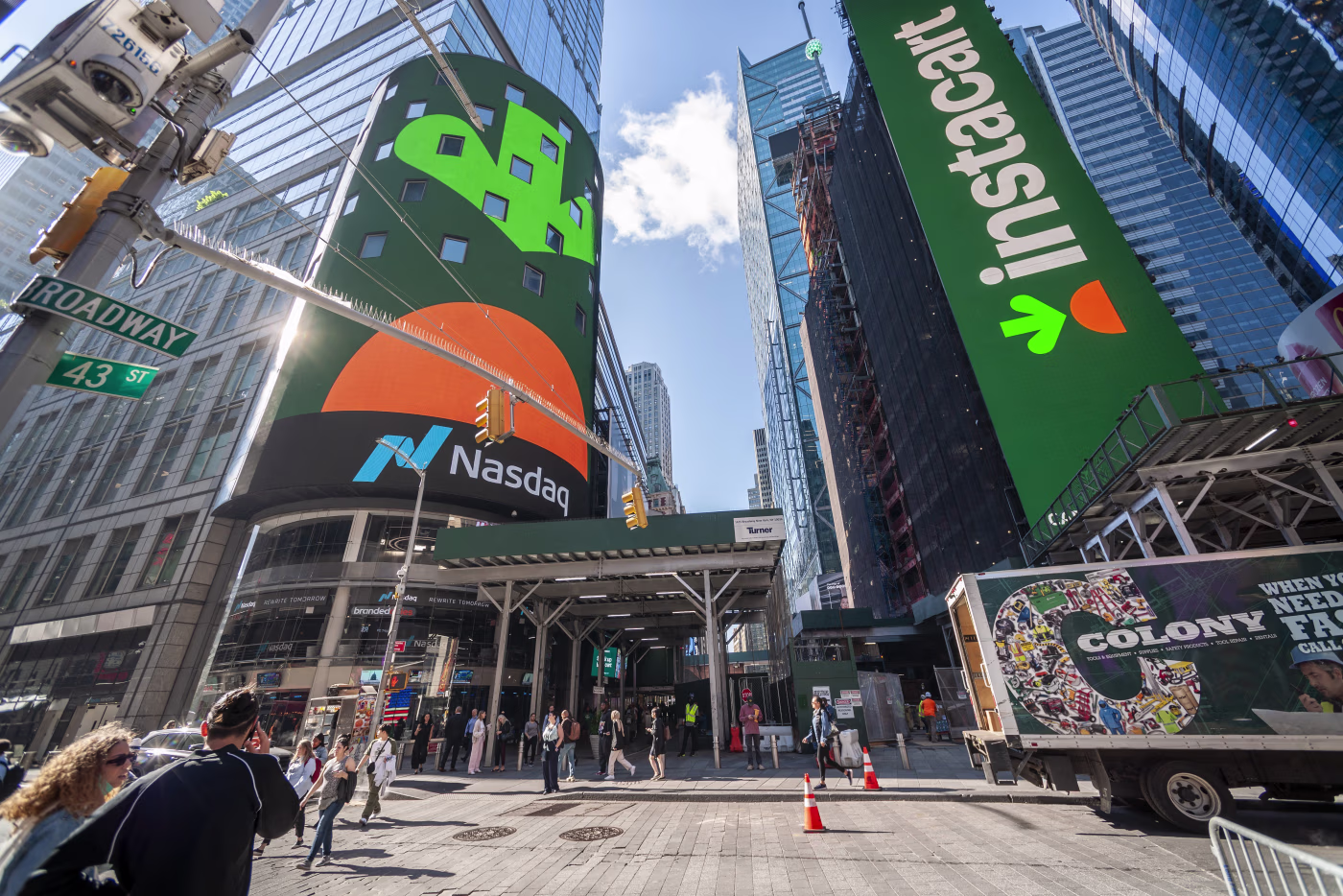 Instacart branding on the Nasdaq tower and a Times Square billboard on IPO day