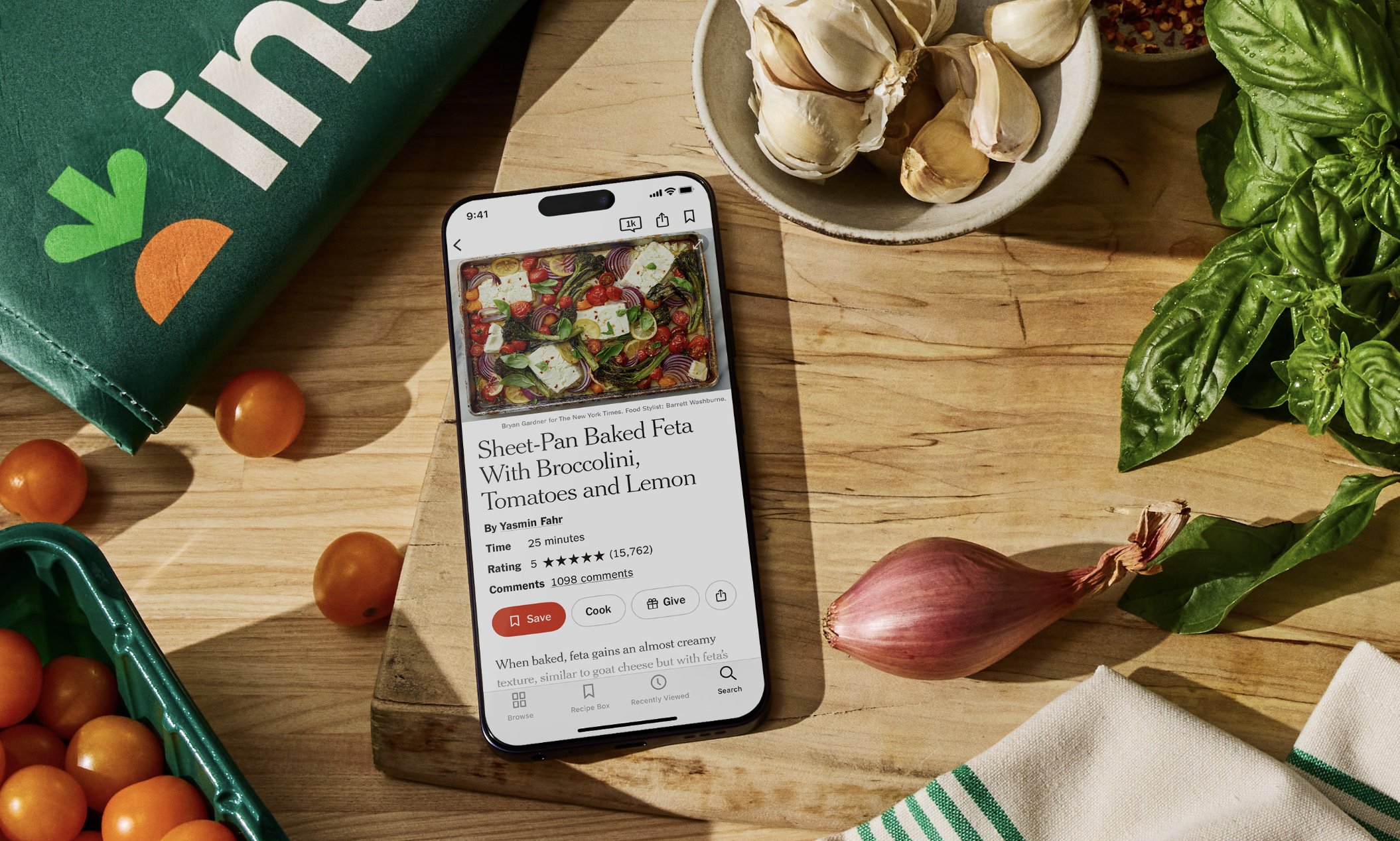 NYT Cooking recipe page with an Instacart cart integration, shown on a phone next to fresh ingredients
